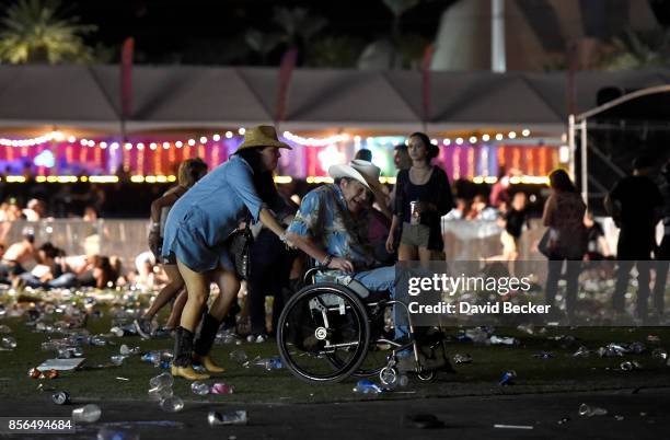 Man in a wheelchair is taken away from the Route 91 Harvest country music festival after apparent gun fire was heard on October 1, 2017 in Las Vegas,...