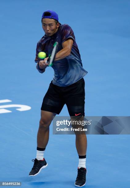 Zhang ze of china returns a shot against Roberto Bautista Agut of Spain during the men's singles first round match on day three of the 2017 China...