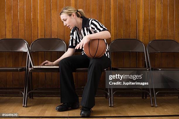 referee with basketball and laptop computer - basketball sideline stock pictures, royalty-free photos & images