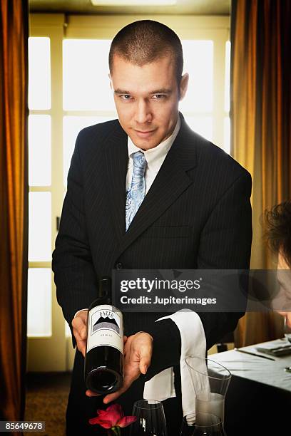sommelier with bottle of wine - sommelier stock pictures, royalty-free photos & images