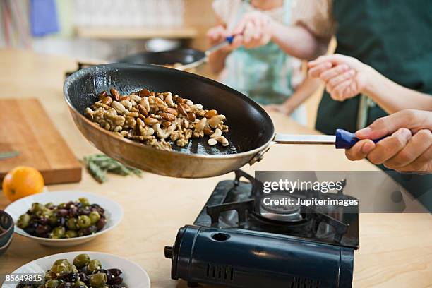 cooking candied nuts - home economics class stock pictures, royalty-free photos & images