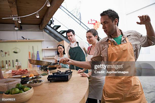 man cooking with skillet - home economics class stock pictures, royalty-free photos & images
