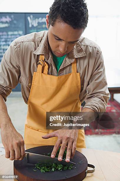 man chopping parsley - chopped herbs stock pictures, royalty-free photos & images