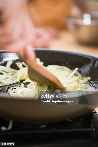 onion saute in skillet - fried stock pictures, royalty-free photos & images