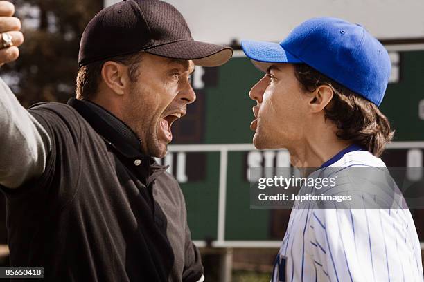 umpire and baseball player arguing - baseball umpire stock pictures, royalty-free photos & images