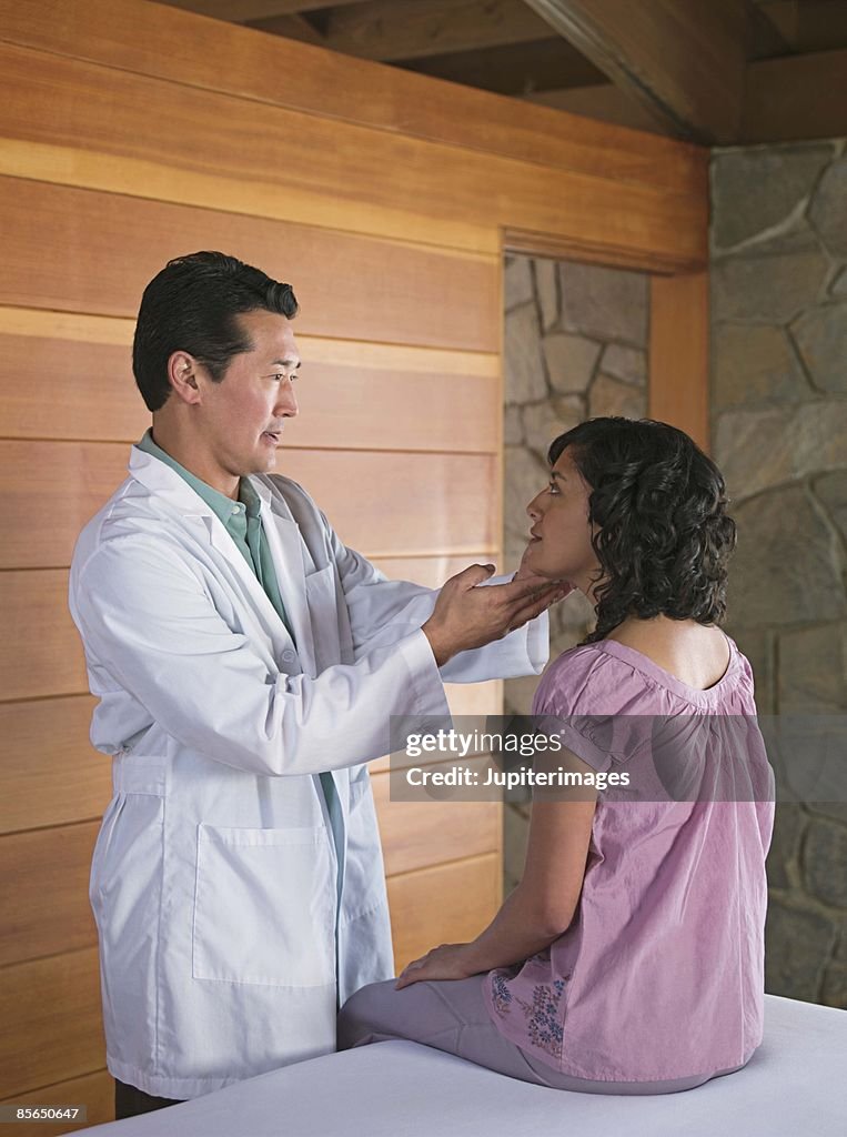 Woman getting check-up with physician