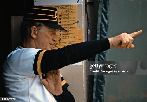 Manager Chuck Tanner of the Pittsburgh Pirates signals from the dugout during a Major League Baseball game against the San Diego Padres at Three...