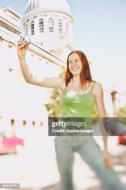 smiling woman holding camera - bonsecours market stock pictures, royalty-free photos & images