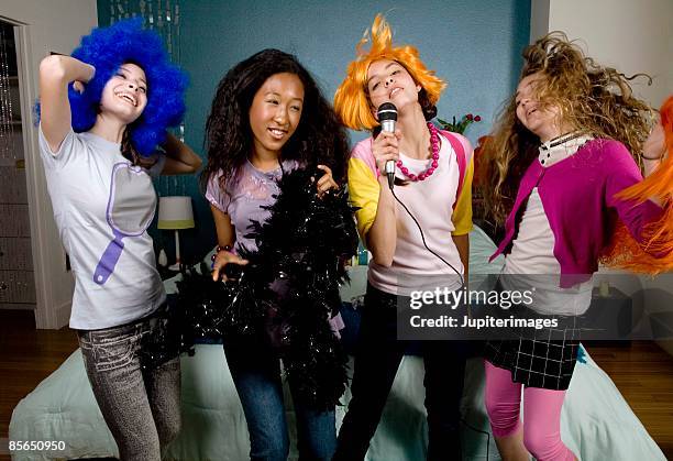 teenage girls in costumes singing - slumber party stock pictures, royalty-free photos & images