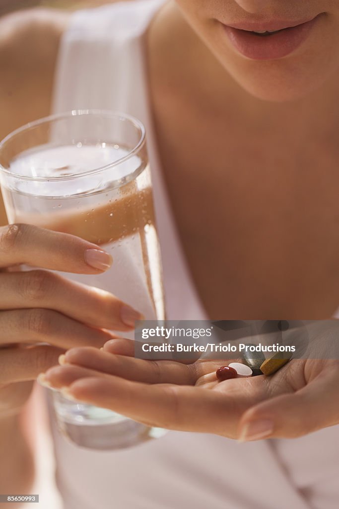 Woman with handful of vitamins
