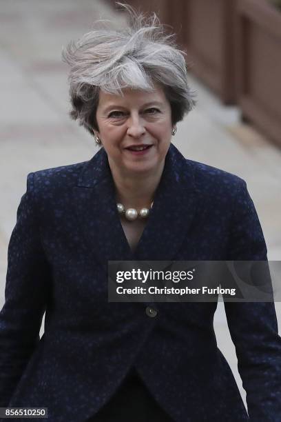 Prime Minister Theresa May walks across the concourse of Manchester Central at the start of day two of the Conservative Party Conference on October...