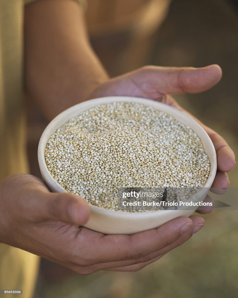 Man holding bowl of quinoa