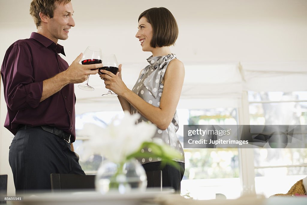 Couple toasting with red wine