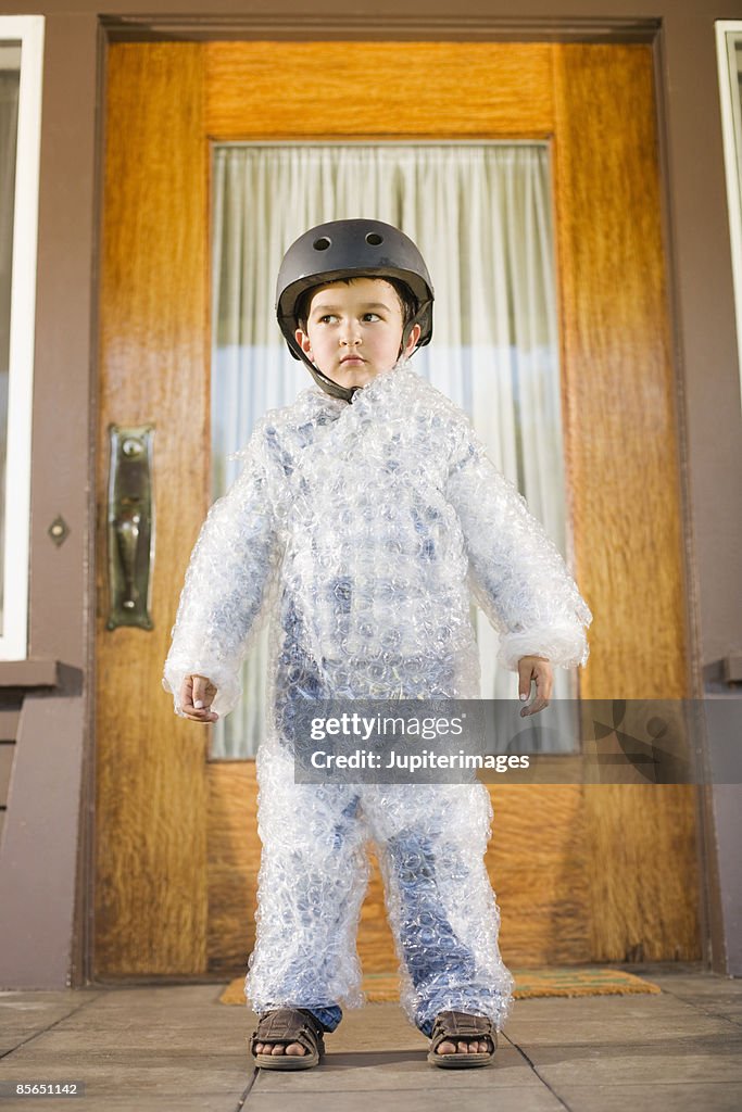 Boy wearing bubble wrap and helmet