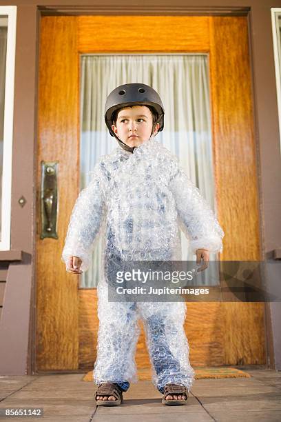 boy wearing bubble wrap and helmet - protection bildbanksfoton och bilder