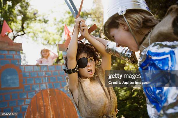 children in playing in costumes - sword fotografías e imágenes de stock