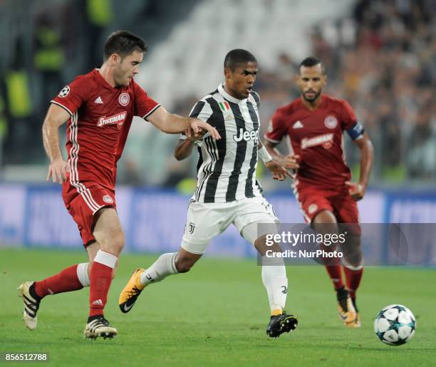 Douglas Costa de Souza of Juventus player, Sasa Zdjelar of Olympiacos player and Alaixys Romao of Olympiacos player during the Uefa Champions League...