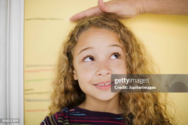 hand measuring growing girl - height stock pictures, royalty-free photos & images