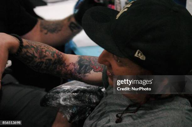 Sevendust drummer Morgan Rose gets tattooed up by the Epic Ink Crew at Walker Stalker Con in Philadelphia on September 30, 2017.