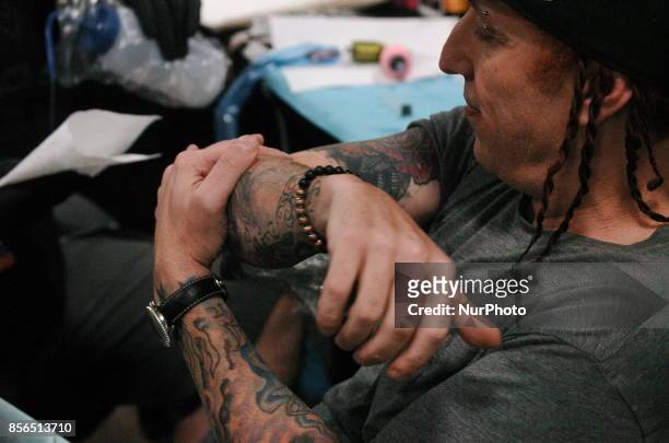 Sevendust drummer Morgan Rose gets tattooed up by the Epic Ink Crew at Walker Stalker Con in Philadelphia on September 30, 2017.