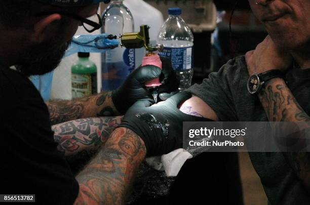 Sevendust drummer Morgan Rose gets tattooed up by the Epic Ink Crew at Walker Stalker Con in Philadelphia on September 30, 2017.