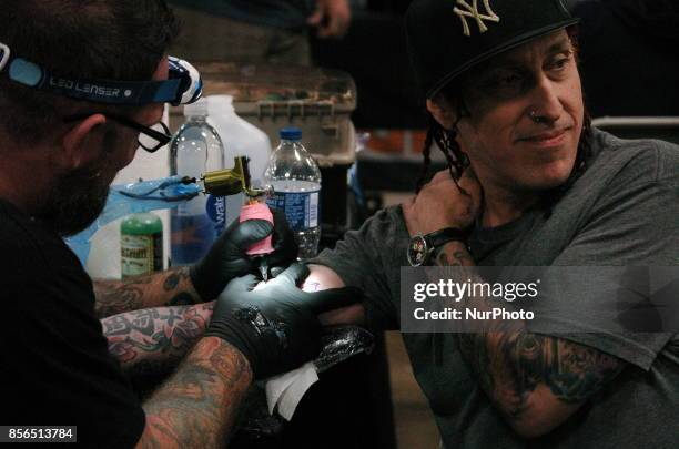 Sevendust drummer Morgan Rose gets tattooed up by the Epic Ink Crew at Walker Stalker Con in Philadelphia on September 30, 2017.