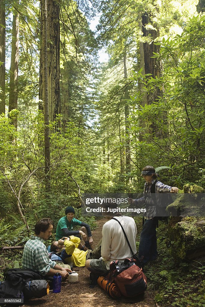 Men sitting in forest