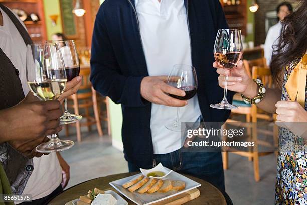 people with wine and food in wine bar - wine bar foto e immagini stock