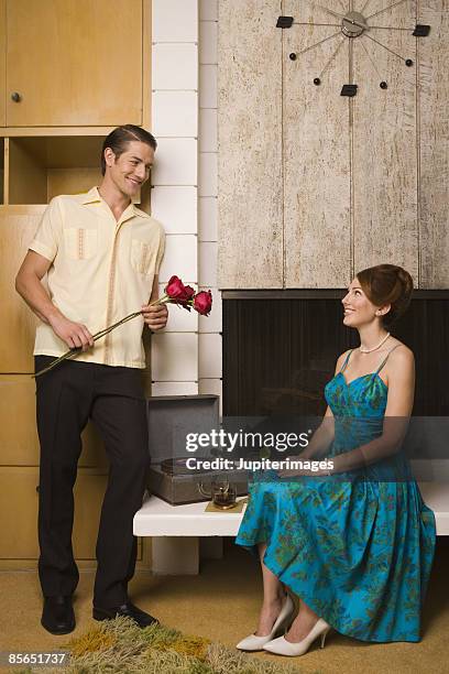 retro couple with roses and cocktails - scotch whisky stock pictures, royalty-free photos & images