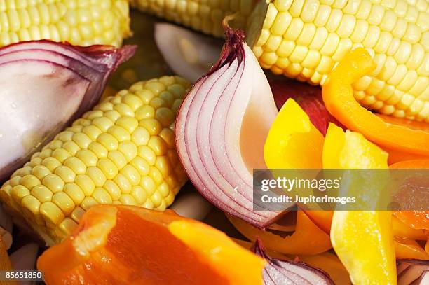 corn on the cob , red onion , and bell pepper - gelbe paprika stock-fotos und bilder