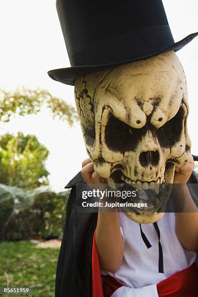 boy in magician costume with skull mask - mask magician stock pictures, royalty-free photos & images