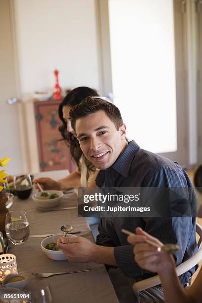 smiling man eating matzoh ball soup - matzo ball soup stock pictures, royalty-free photos & images