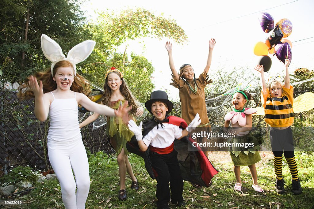 Excited children in Halloween costumes