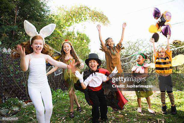 excited children in halloween costumes - black bunny costume foto e immagini stock