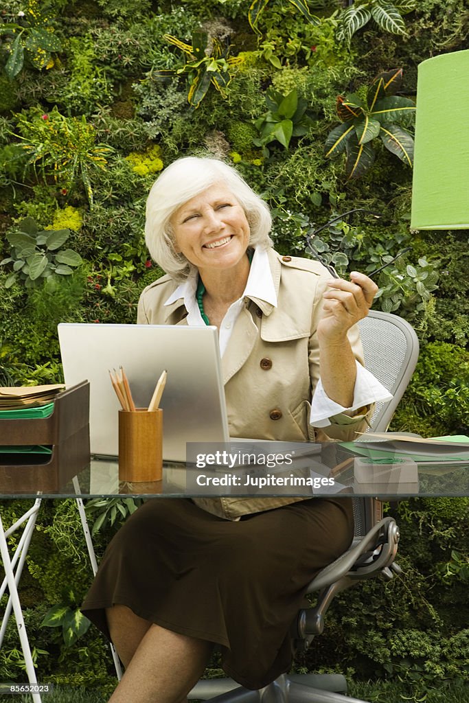 Smiling woman working outdoors