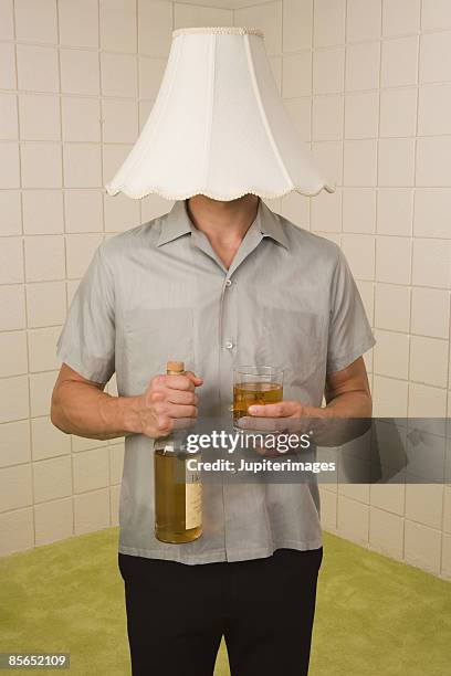 man with lampshade on head - lampenschirm stock-fotos und bilder