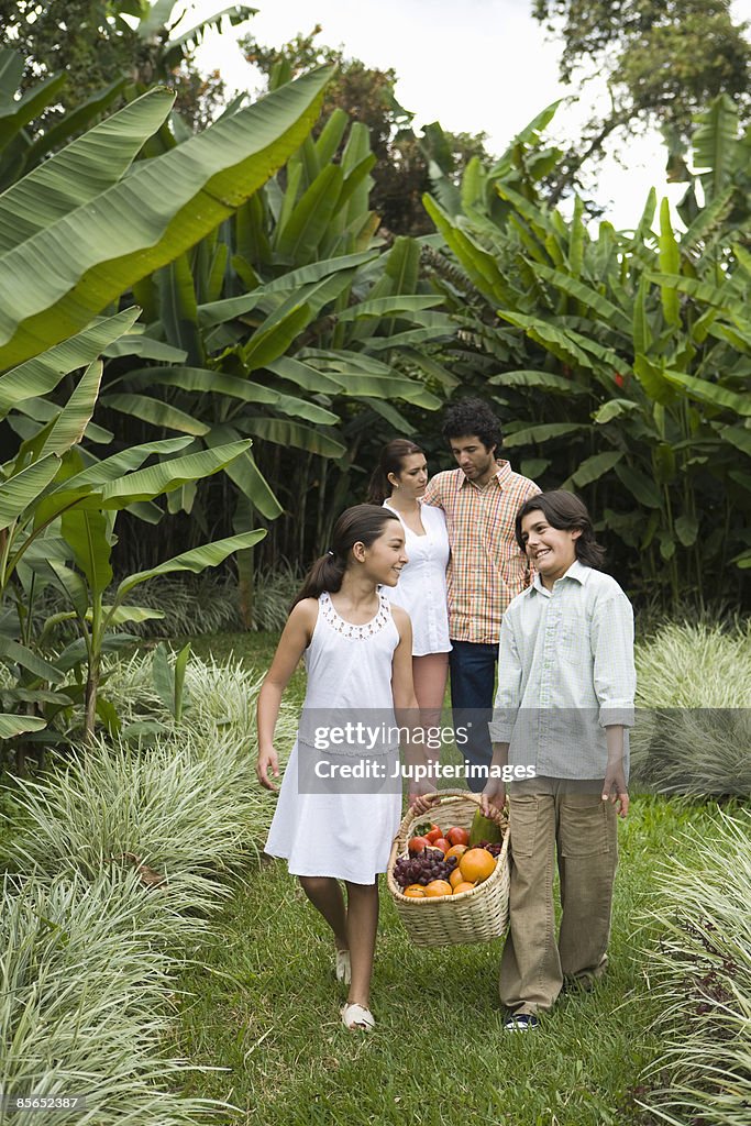 Family with basket of tropical fruit