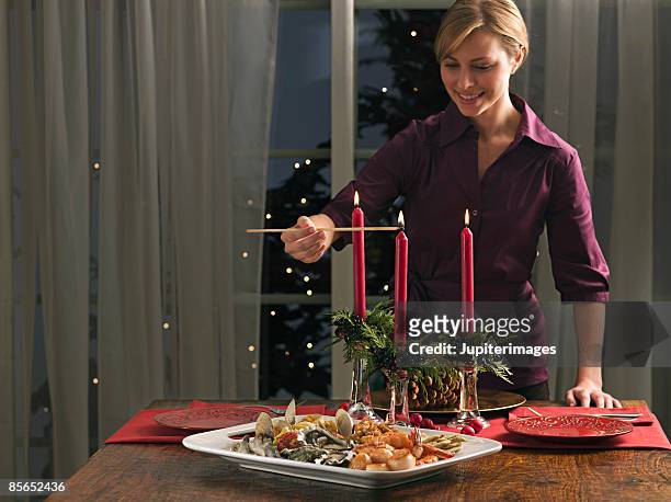 woman lighting candles and seafood platter - seafood platter bildbanksfoton och bilder