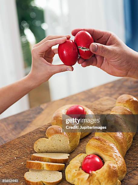 hands with greek easter bread and eggs - greece easter stock pictures, royalty-free photos & images
