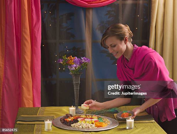 woman with platter of diwali sweets - diwali sweets stock pictures, royalty-free photos & images