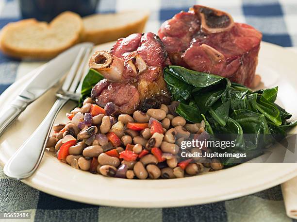 southern new year's meal with greens, beans, and ham hocks - black eyed pea stock pictures, royalty-free photos & images