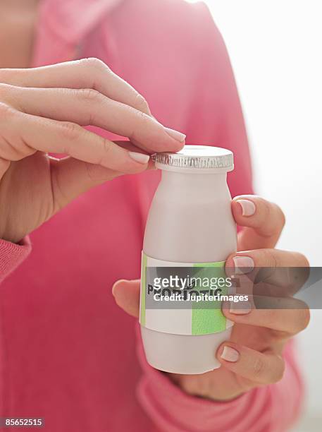 person with bottle of probiotic drink - probiotic stock pictures, royalty-free photos & images