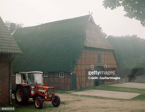 tractor and farmhouse , germany - lower saxony stock pictures, royalty-free photos & images