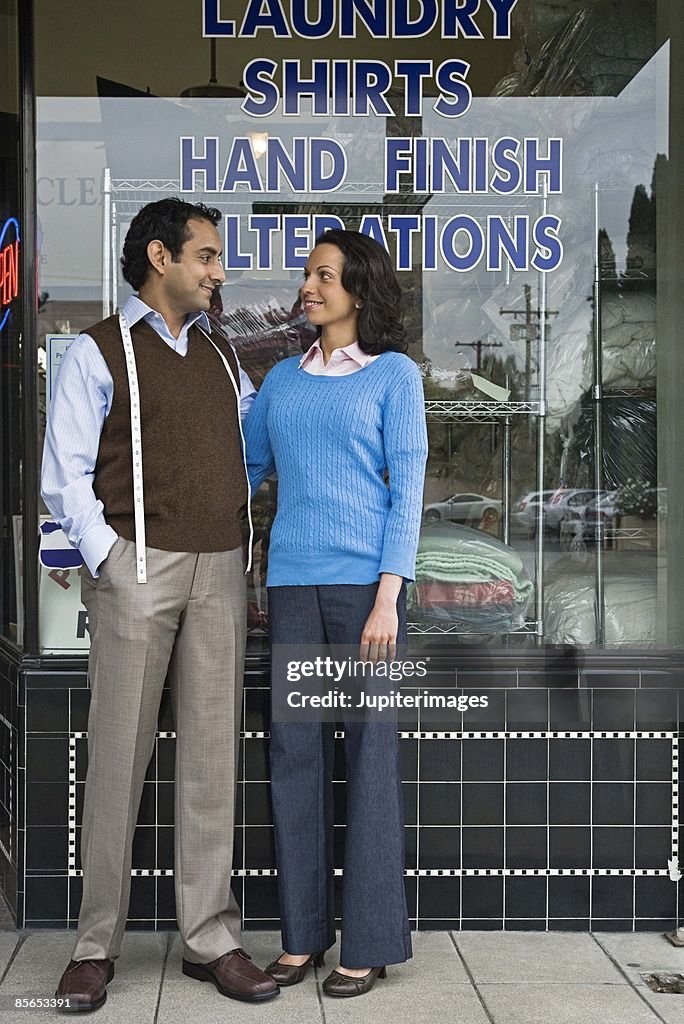 Small business owners in front of dry cleaners shop