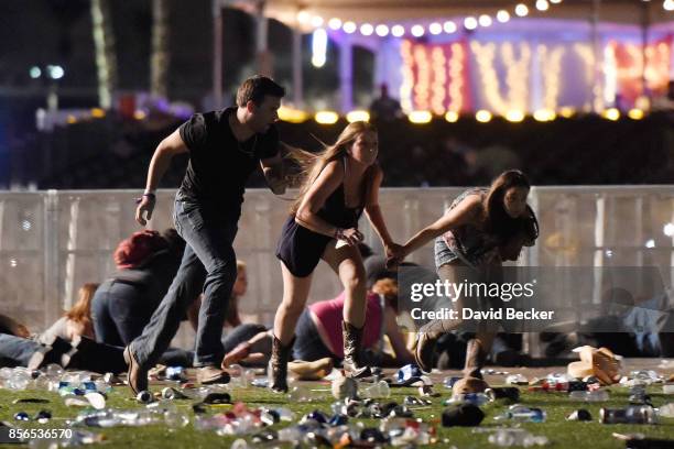 People run from the Route 91 Harvest country music festival after apparent gun fire was hear on October 1, 2017 in Las Vegas, Nevada. A gunman has...