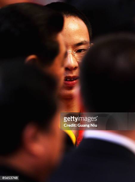 The Panchen Lama, Gyaltsen Norbu, looks at Jia Qinglin , Chairman of the Chinese People's Political Consultative Conference after a government...
