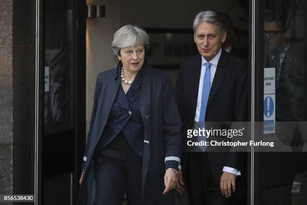 Prime Minister Theresa May and Chancellor of the Exchequer Phillip Hammond leave the Midland Hotel at the start of day two of the Conservative Party...