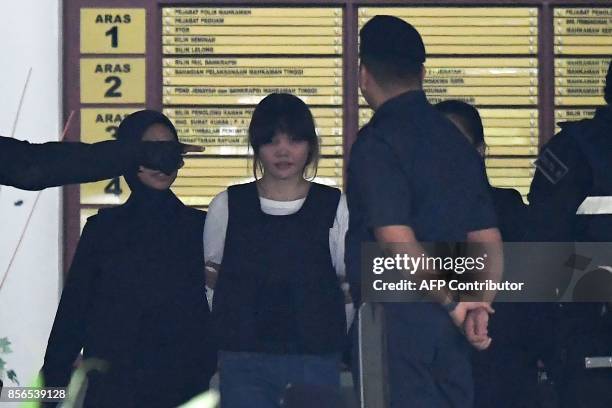 Royal Malaysian Police escort Vietnamese defendant Doan Thi Huong after her trial at the Shah Alam High Court in Shah Alam, outside Kuala Lumpur on...