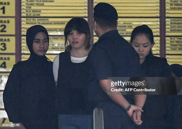 Royal Malaysian Police escort Vietnamese defendant Doan Thi Huong after her trial at the Shah Alam High Court in Shah Alam, outside Kuala Lumpur on...