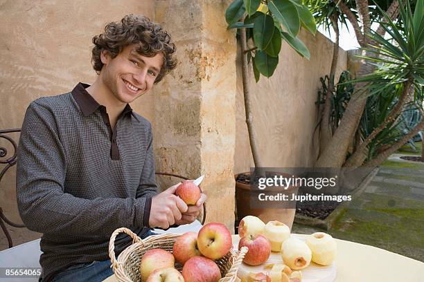 man peeling apples - peeler stock pictures, royalty-free photos & images